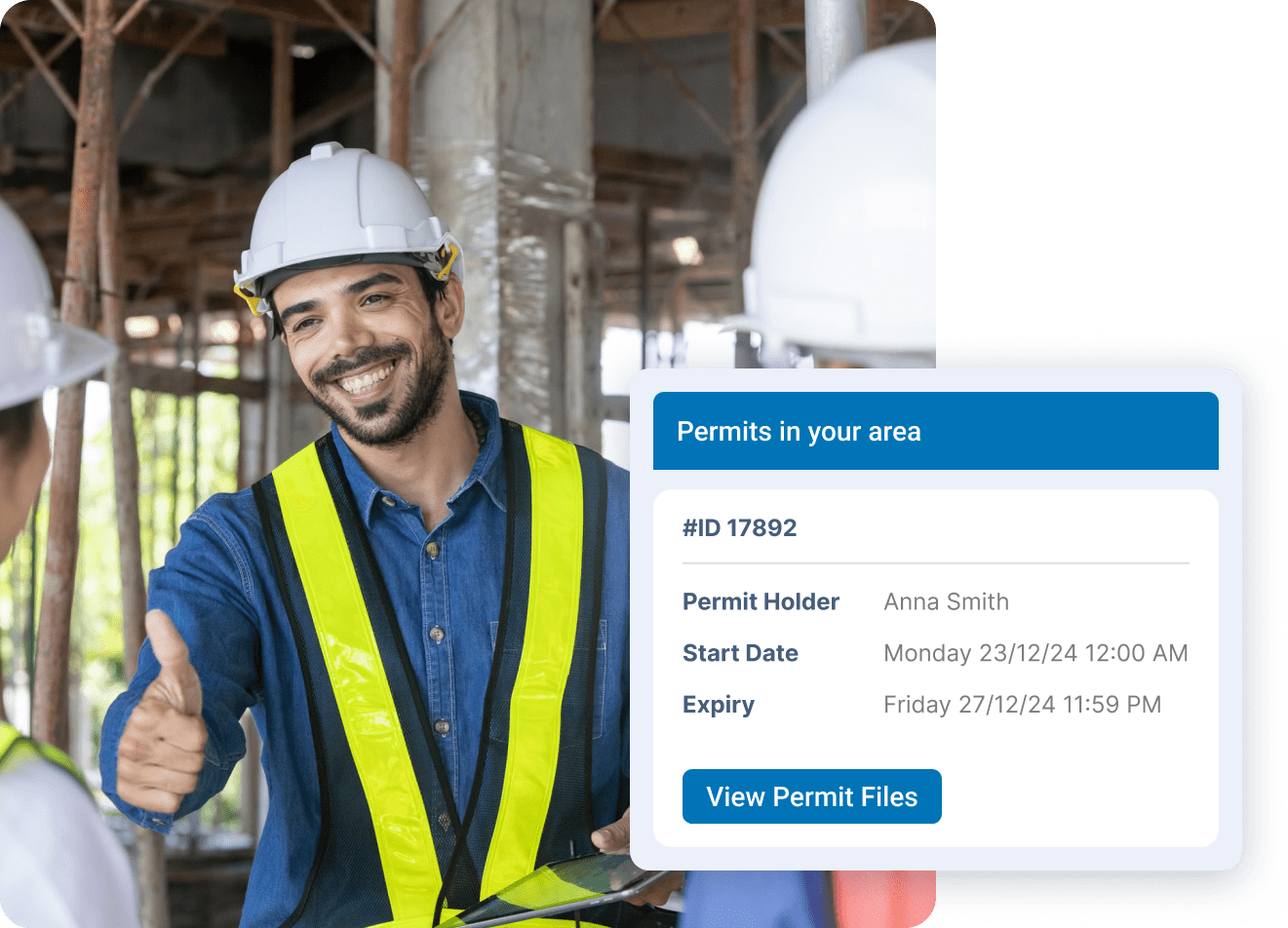 Smiling construction worker in hard hat giving thumbs up with permit details displayed